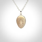 Hand made woolly mammoth tusk moon face necklace. Made by NZ Pacific and sale online only.